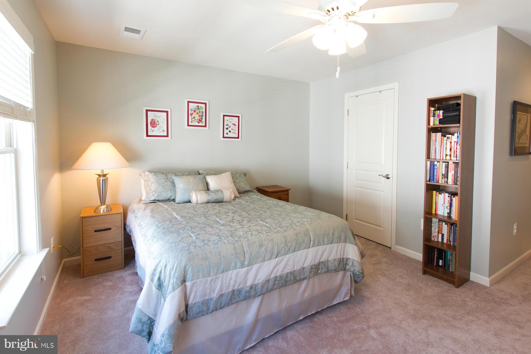 3419 Kemper Road Arlington, VA 22206 - Photo 12 of 30 a bedroom with a bed and a chandelier