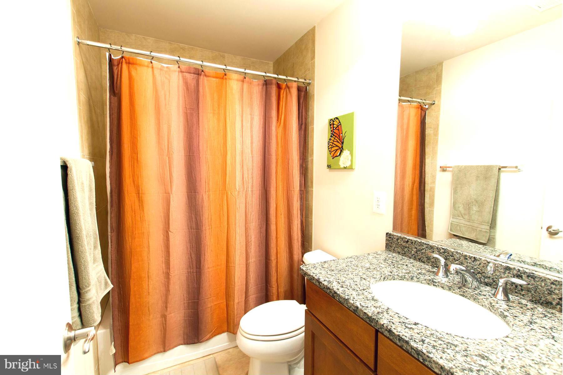 3419 Kemper Road Arlington, VA 22206 - Photo 16 of 30 a bathroom with a granite countertop sink and a mirror