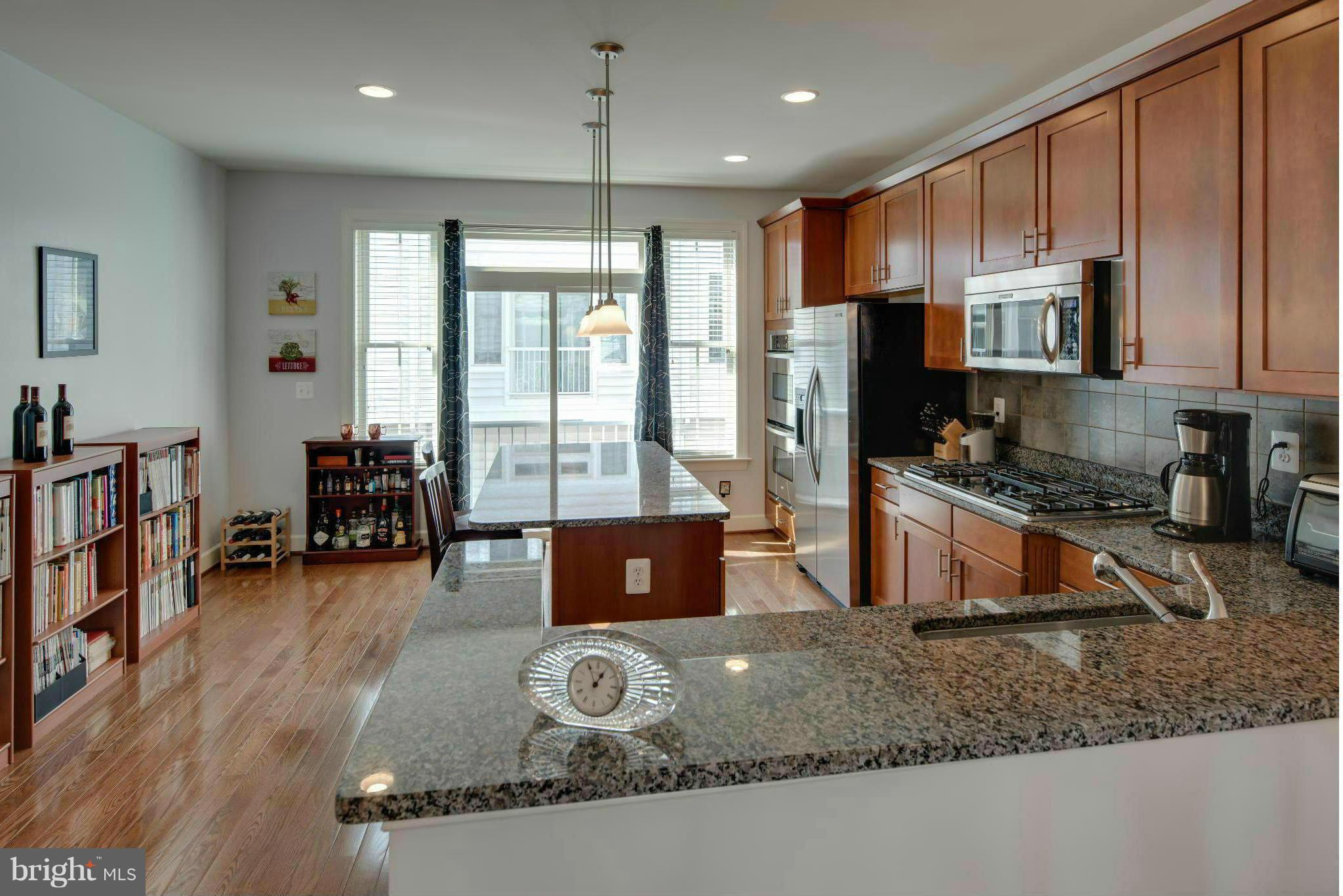 3419 Kemper Road Arlington, VA 22206 - Photo 4 of 30 a kitchen with sink a refrigerator and cabinets