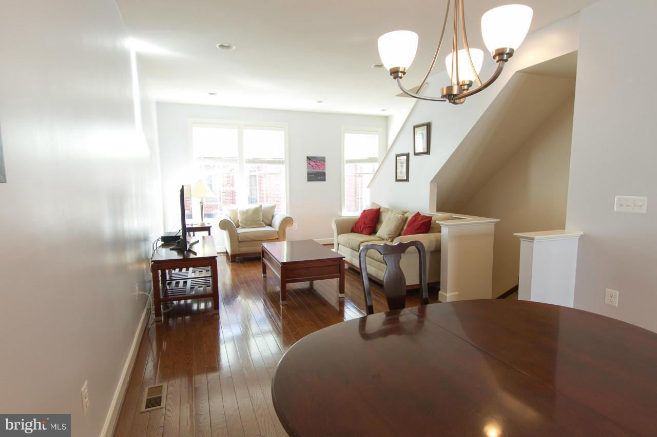 3419 Kemper Road Arlington, VA 22206 - Photo 8 of 30 a living room with furniture wooden floor and a chandelier