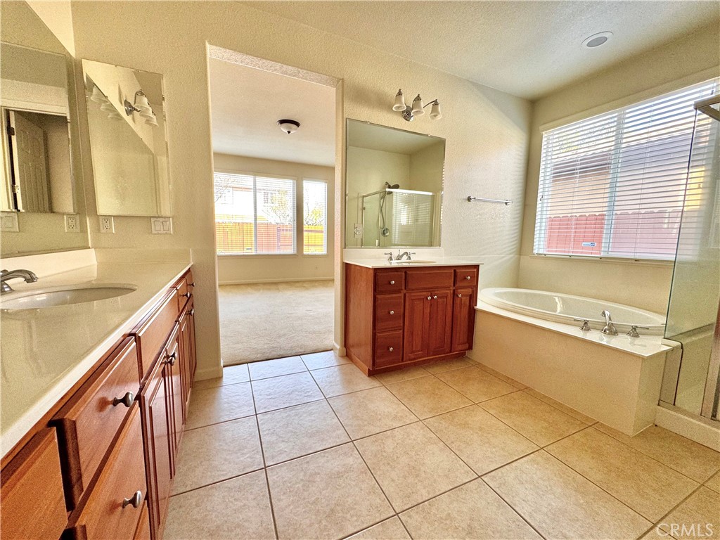 129 Walker Ranch Parkway Patterson, CA 95363 - Photo 4 of 7 a bathroom with a tub sink and mirror
