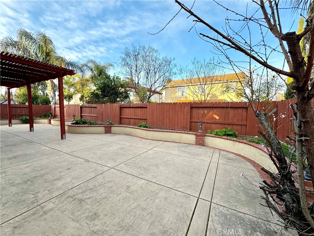 129 Walker Ranch Parkway Patterson, CA 95363 - Photo 7 of 7 a view of backyard with a table and chair under an umbrella