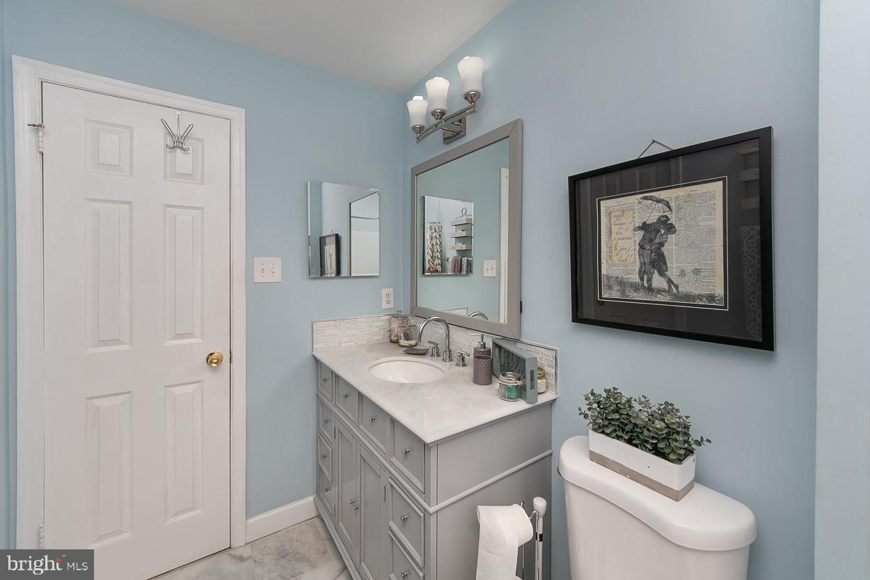 3504 Corn Stream Road Randallstown, MD 21133 - Photo 19 of 34 a bathroom with a toilet a sink and a mirror
