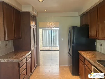 a kitchen with granite countertop wood cabinets and stainless steel appliances