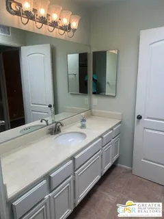 a bathroom with a glass shower door