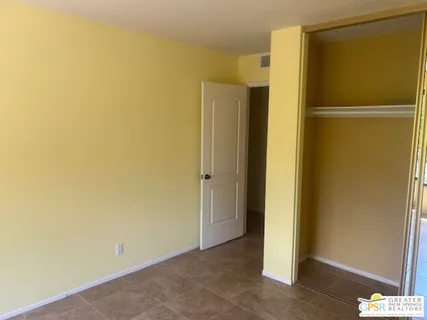 a view of a house with a large window and a yard
