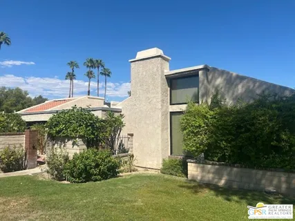 a view of a big yard with swimming pool and green space