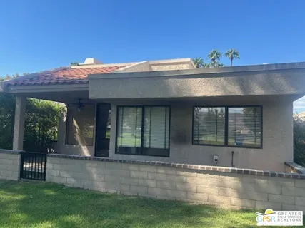 a view of a big yard with a large trees