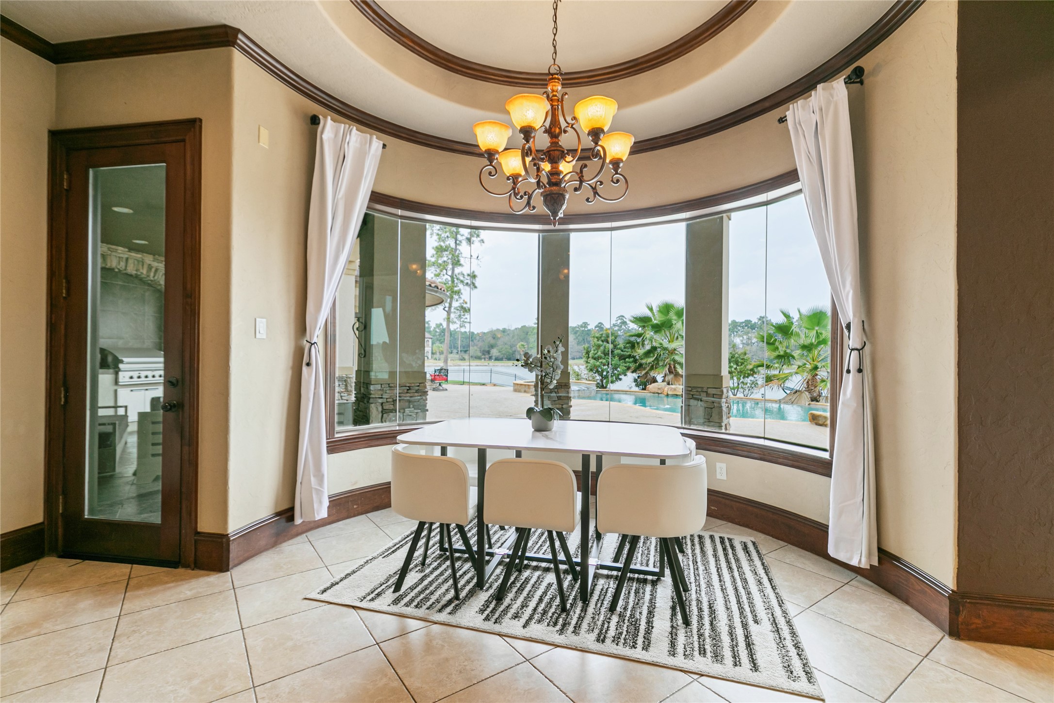 22 Post Shadow Estate Drive Spring, TX 77389 - Photo 25 of 50 a dining room with wooden floor a chandelier a glass table and windows