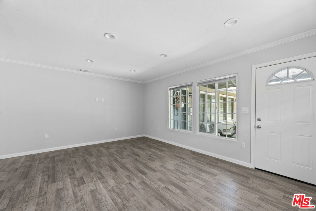 1960 North Ontario Street Burbank, CA 91505 - Photo 4 of 16 a view of an empty room with wooden floor and a window