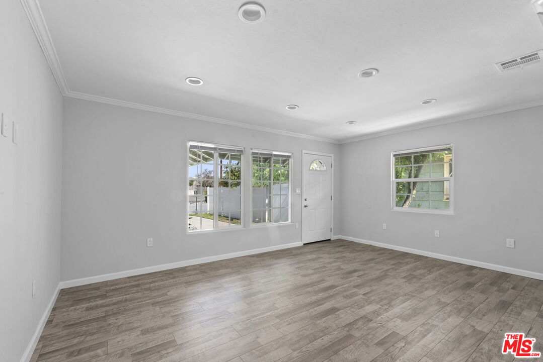 1960 North Ontario Street Burbank, CA 91505 - Photo 6 of 16 an empty room with wooden floor and windows