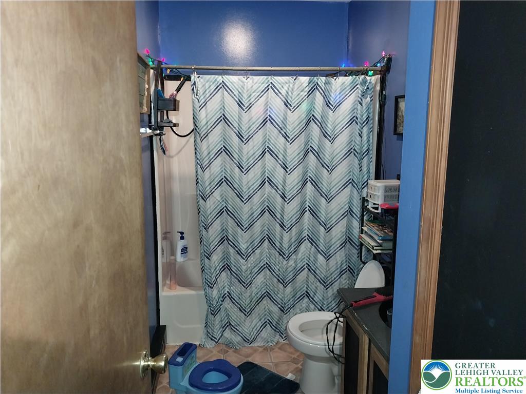 2108 Fox Road Bushkill, PA 18324 - Photo 48 of 98 a bathroom with a shower curtain and a sink