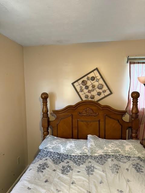 6495 Revena Drive Morrow, GA 30260 - Photo 12 of 14 a bedroom with a bed and cabinets