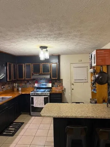a kitchen with stainless steel appliances granite countertop a sink and cabinets