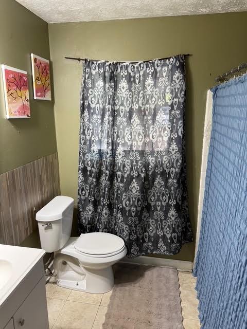6495 Revena Drive Morrow, GA 30260 - Photo 7 of 14 a white toilet sitting next to a shower curtain