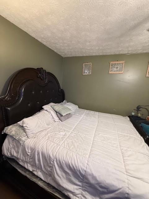 6495 Revena Drive Morrow, GA 30260 - Photo 9 of 14 a bedroom with a bed and a night stand