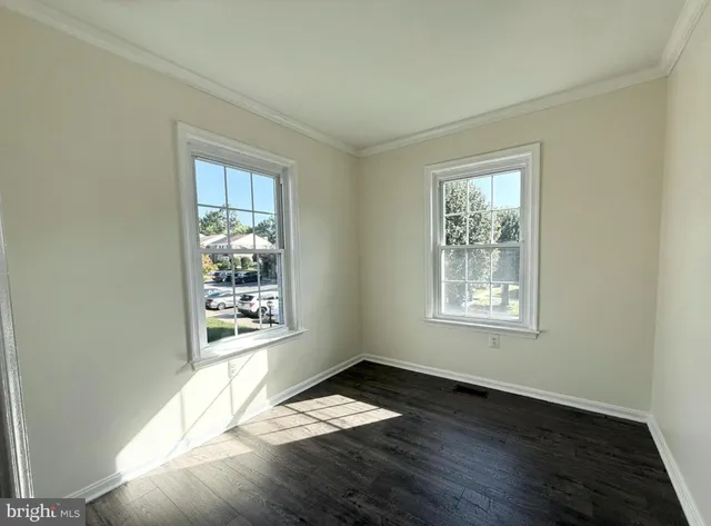 a view of wooden floor and windows in an empty room