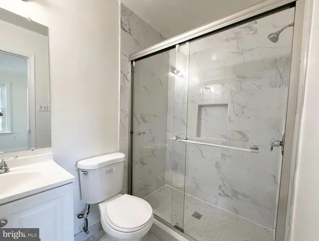 a white toilet sitting next to a bathroom sink