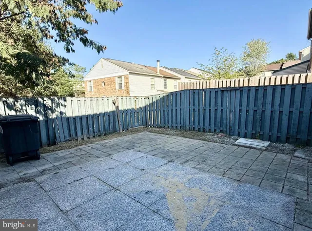 a view of a backyard with wooden fence