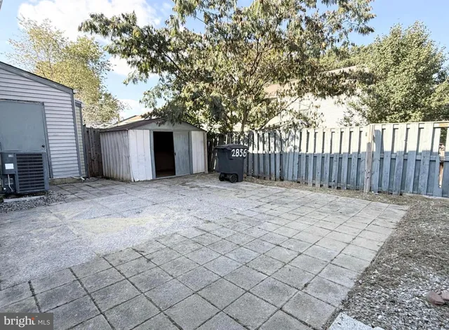 a backyard of a house with wooden fence