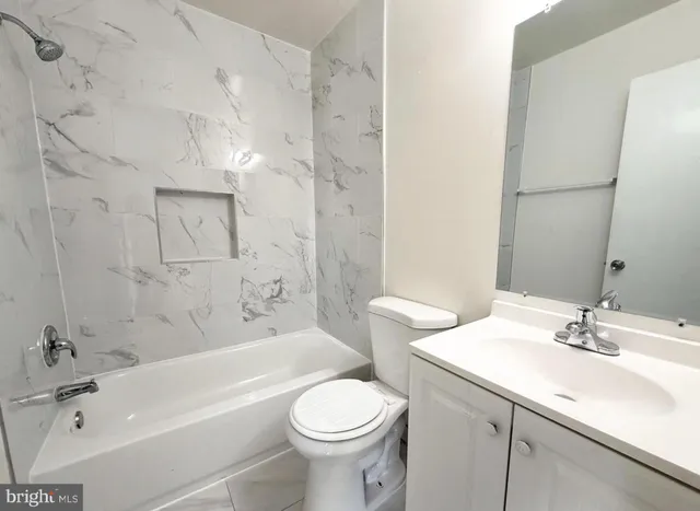 a bathroom with a sink a toilet and a bathtub