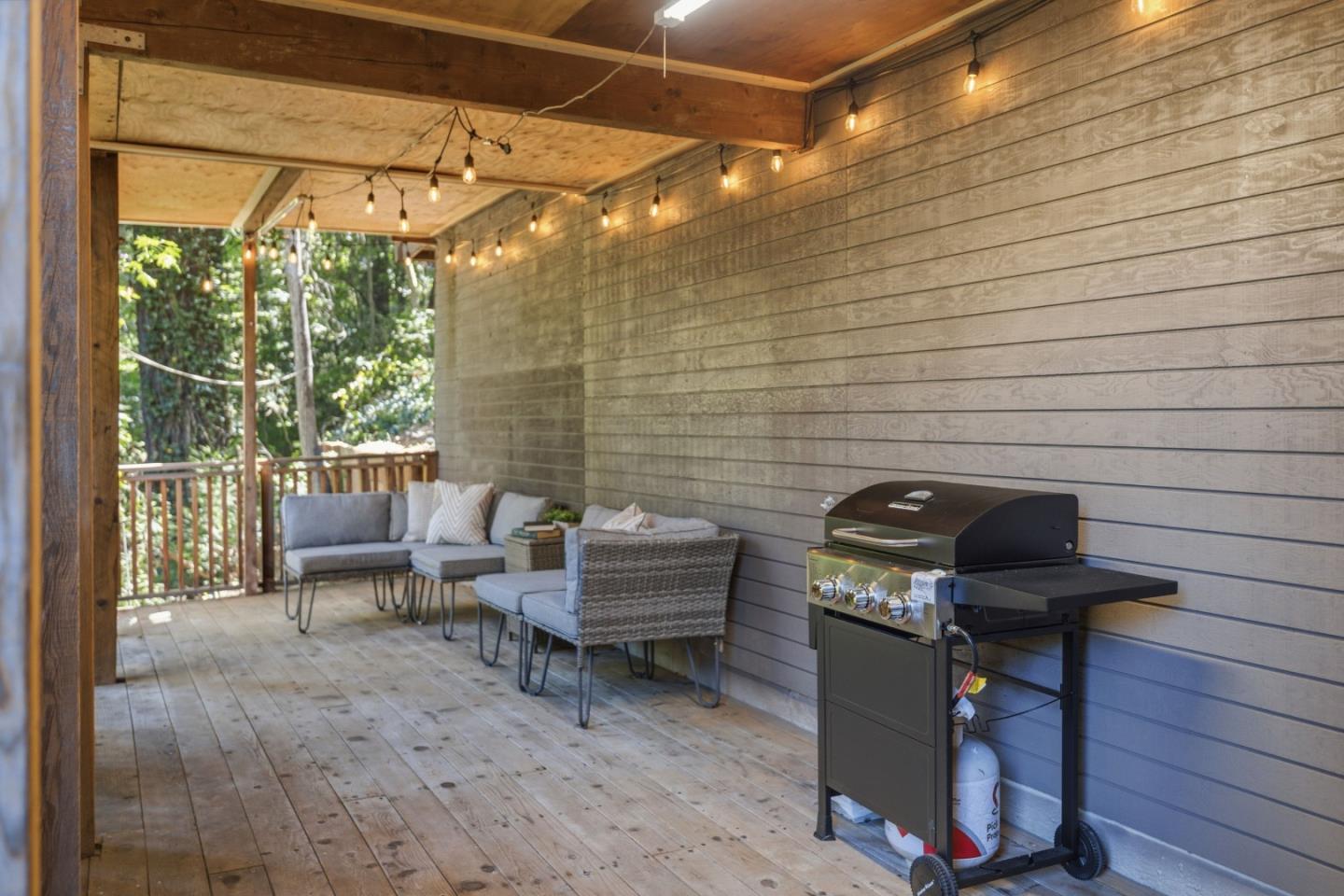 320 Fireside Road Boulder Creek, CA 95006 - Photo 20 of 45 a view of a patio with table and chairs with wooden floor