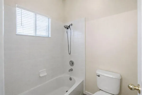 a spacious bathroom with a double vanity sink a mirror and a bathtub