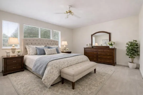 a bedroom with a bed and a window