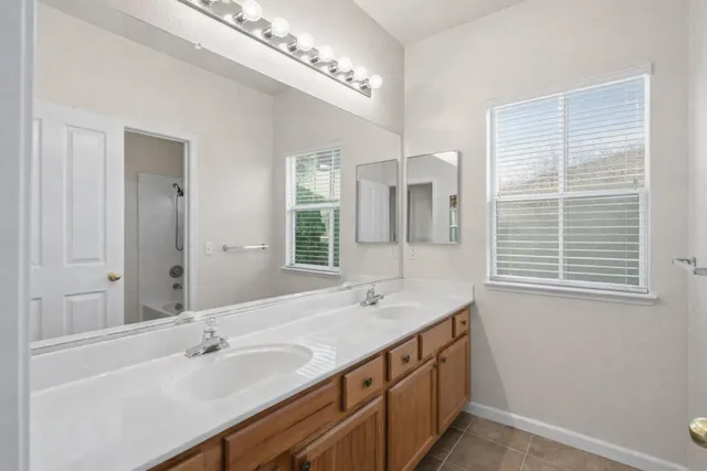 a view of a livingroom with entryway wooden floor and chandelier