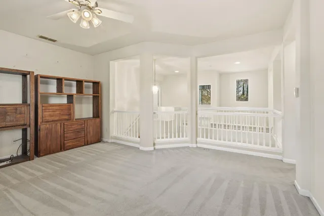 a front view of a house with garden and plants