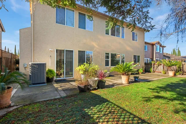 a view of a patio with a table and chairs with wooden floor and fence