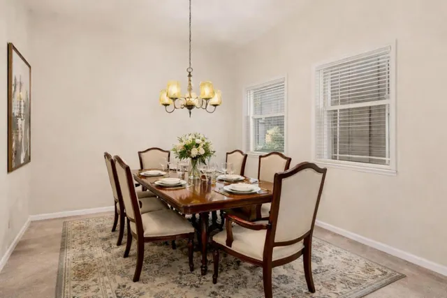 a view of a dining room with furniture and chandelier