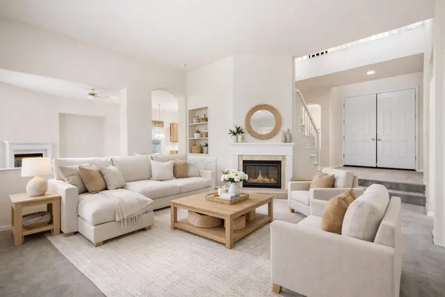 a living room with furniture and a fireplace