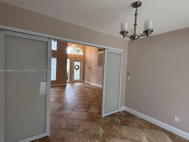a view of staircase with railing and white walls