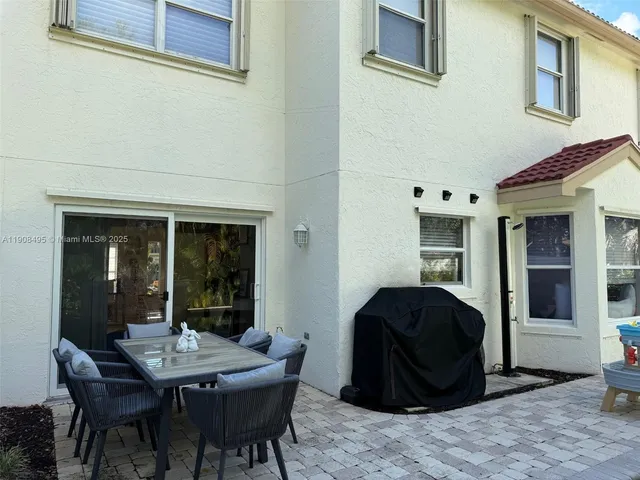 a swimming pool with outdoor seating yard and barbeque oven
