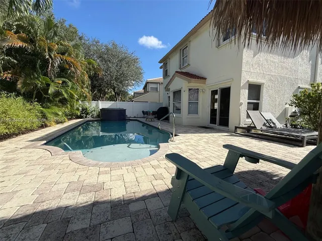 a backyard of a house with table and chairs
