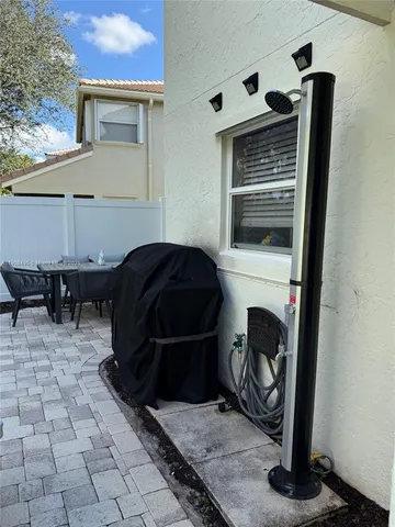 a view of a house with pool and sitting area