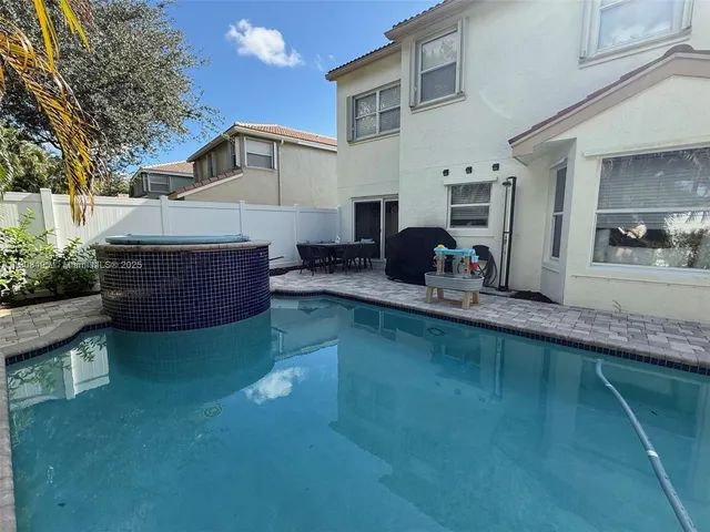 a view of a chairs and table in the patio