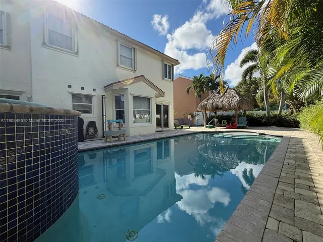a view of a house with backyard sitting area and garden