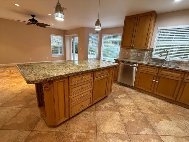 a kitchen with stainless steel appliances granite countertop a sink and cabinets