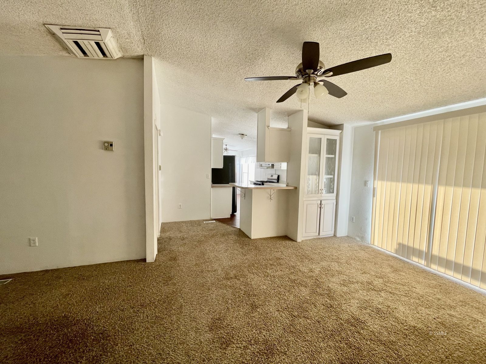 1465 Pony Street Ridgecrest, CA 93555 - Photo 6 of 32 a view of empty room with wooden floor and ceiling fan