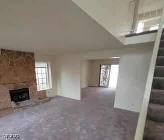 2813 Cacto Court Henderson, NV 89074 - Photo 26 of 28 Unfurnished living room featuring stairs and a fireplace