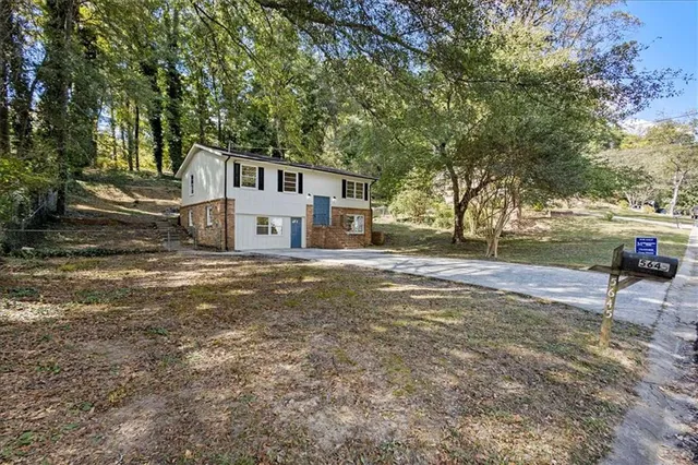 a house that has a tree in front of it