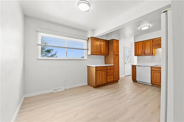 a kitchen with stainless steel appliances a refrigerator and a stove top oven