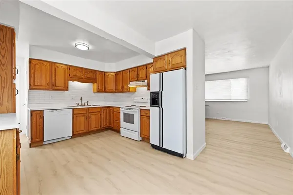 a kitchen with stainless steel appliances a refrigerator sink and cabinets