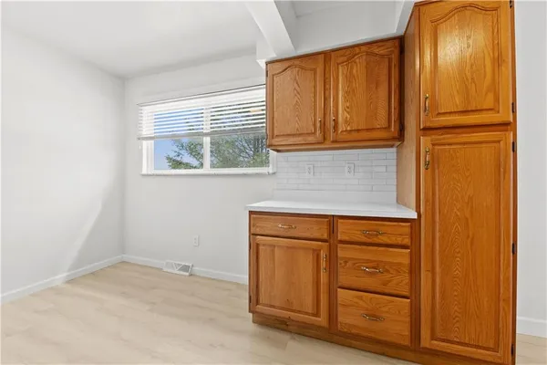 a view of a kitchen with granite countertop cabinets and a window