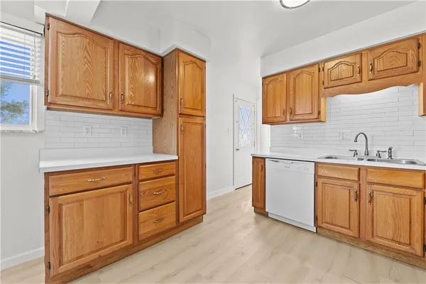 a kitchen with stainless steel appliances granite countertop a sink and cabinets