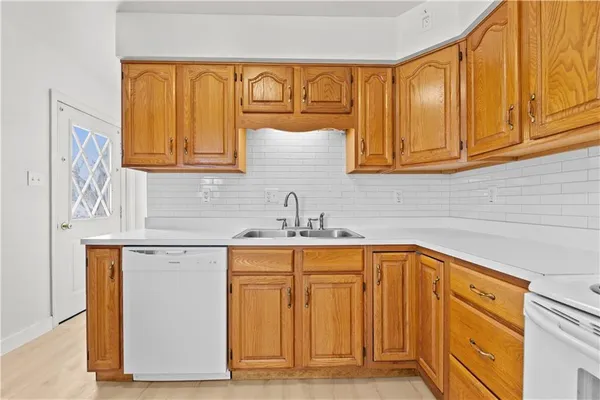 a kitchen with stainless steel appliances granite countertop a sink and cabinets with wooden floor