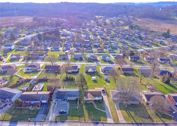 an aerial view of residential houses with outdoor space and seating area