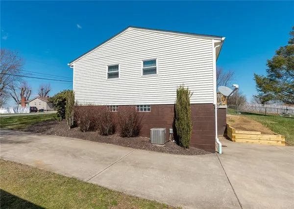 a view of a house with backyard and a garage